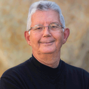 Jim Hollan headshot presenting as a Caucasian male with white hair and glasses wearing a black shirt